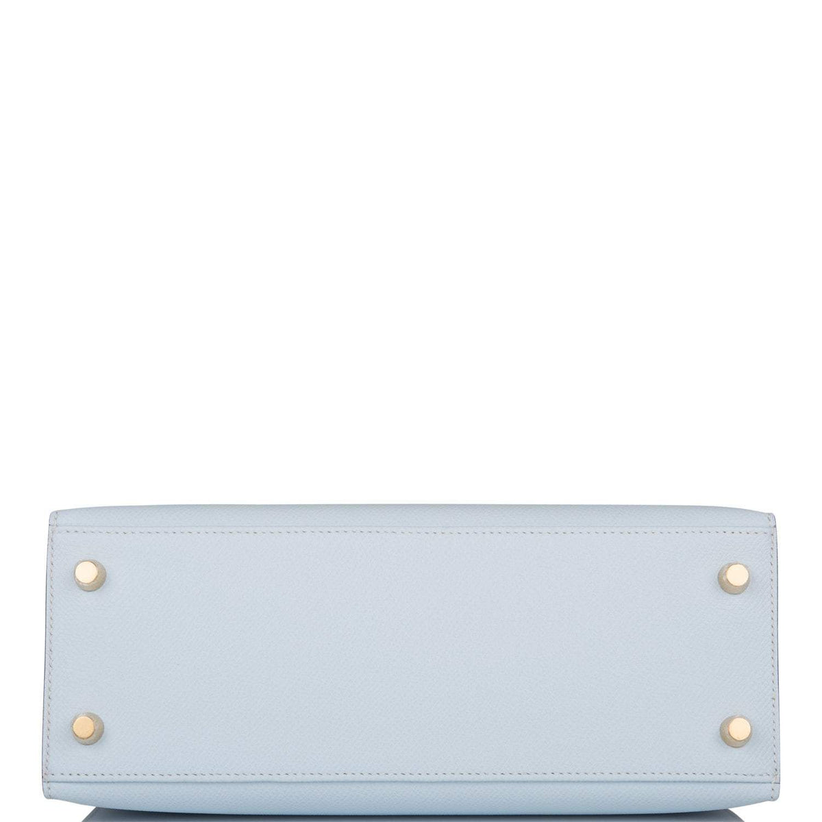 The bag being carried by hand, showcasing its compact size and handle drop