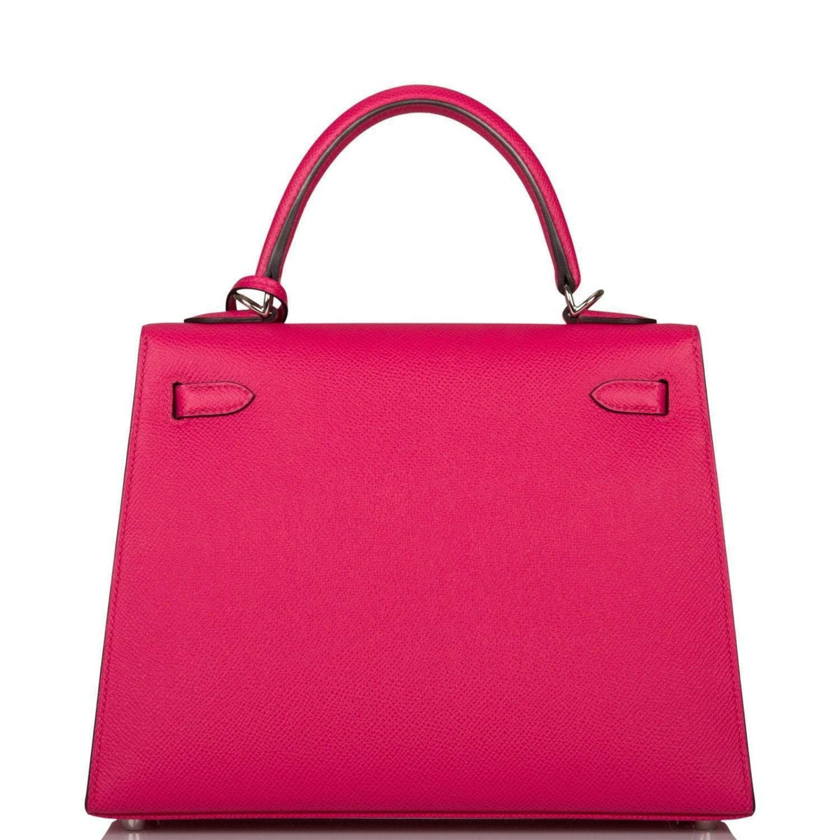 The Rose Mexico Epsom Kelly 25 being held by a hand, showing its compact scale