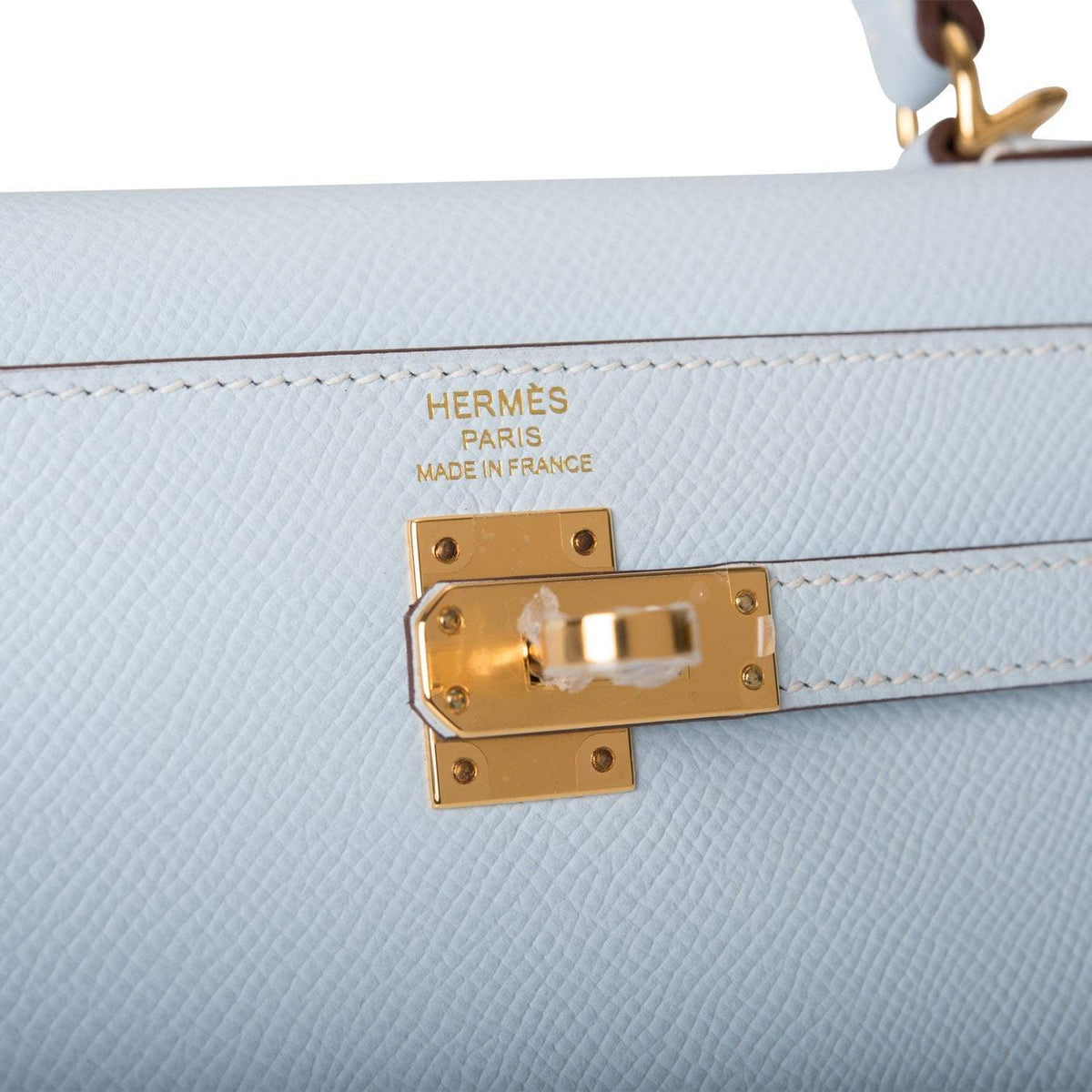 A shot of the removable shoulder strap and its gold-tone clasps