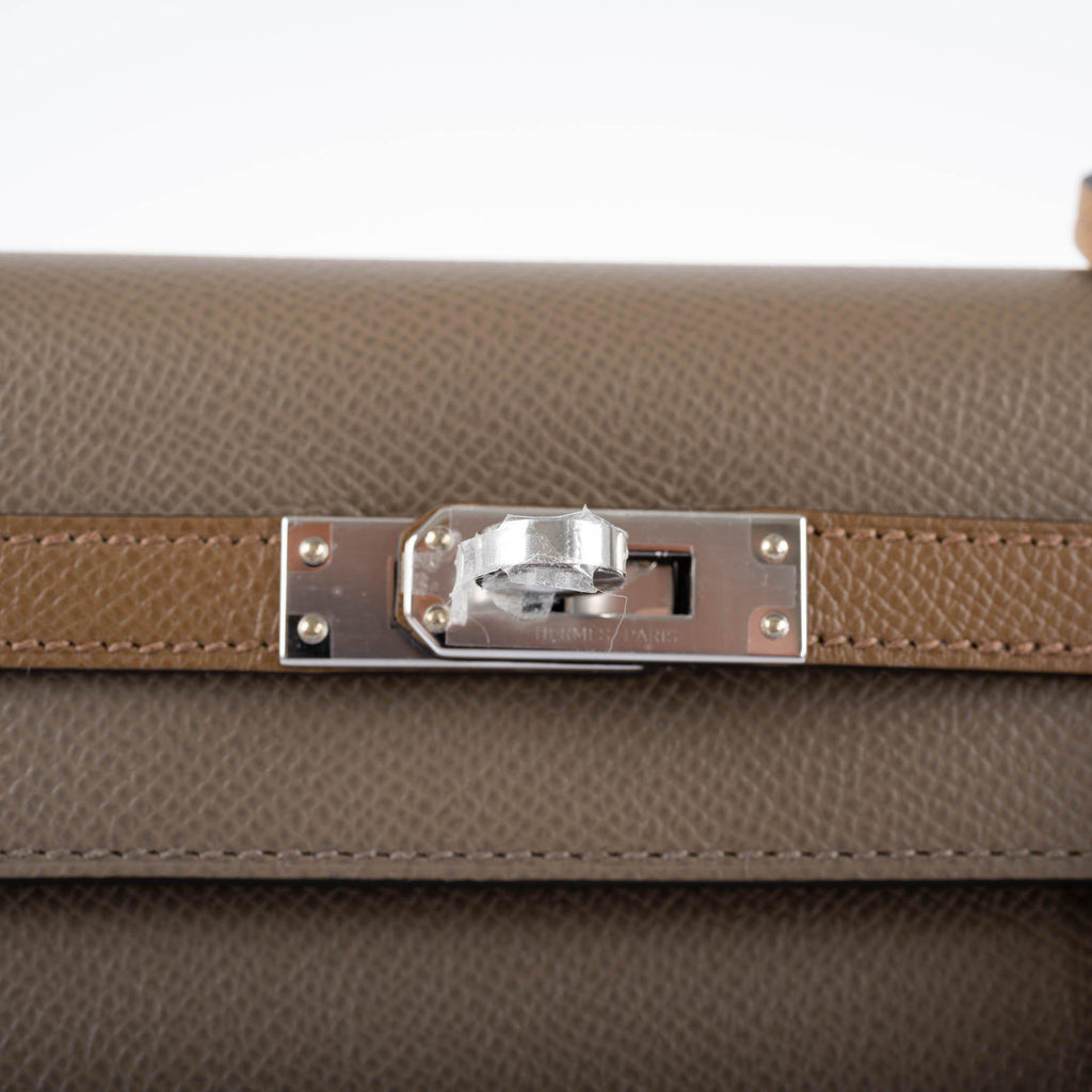 The tri-color handbag resting on a flat surface