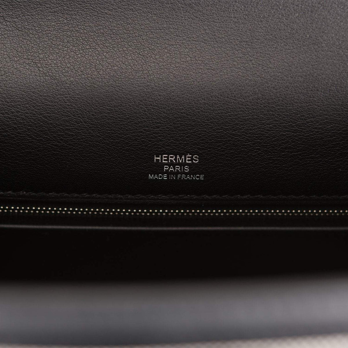 Image of the interior, showing the zip pocket and two open pockets