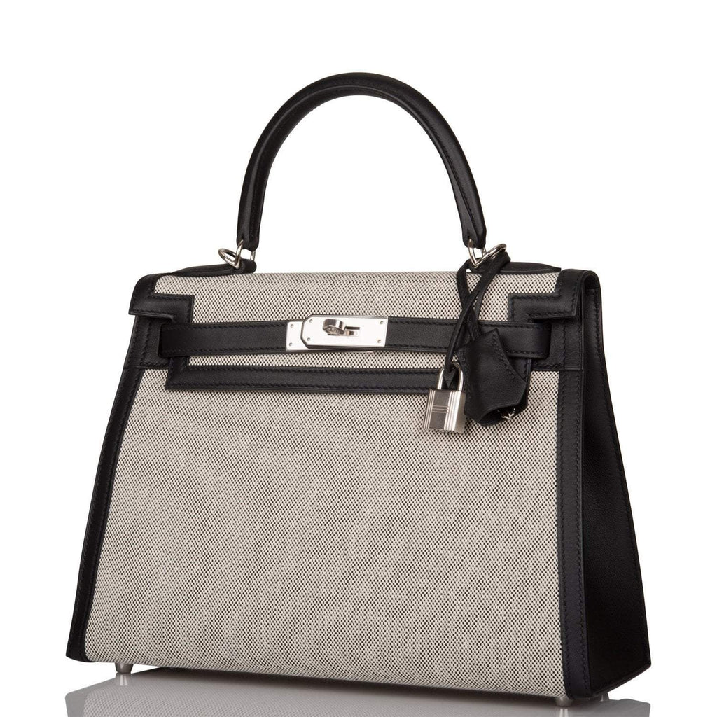 A view of the signature palladium-tone turn-lock on the front flap of the bag