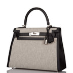 A view of the signature palladium-tone turn-lock on the front flap of the bag