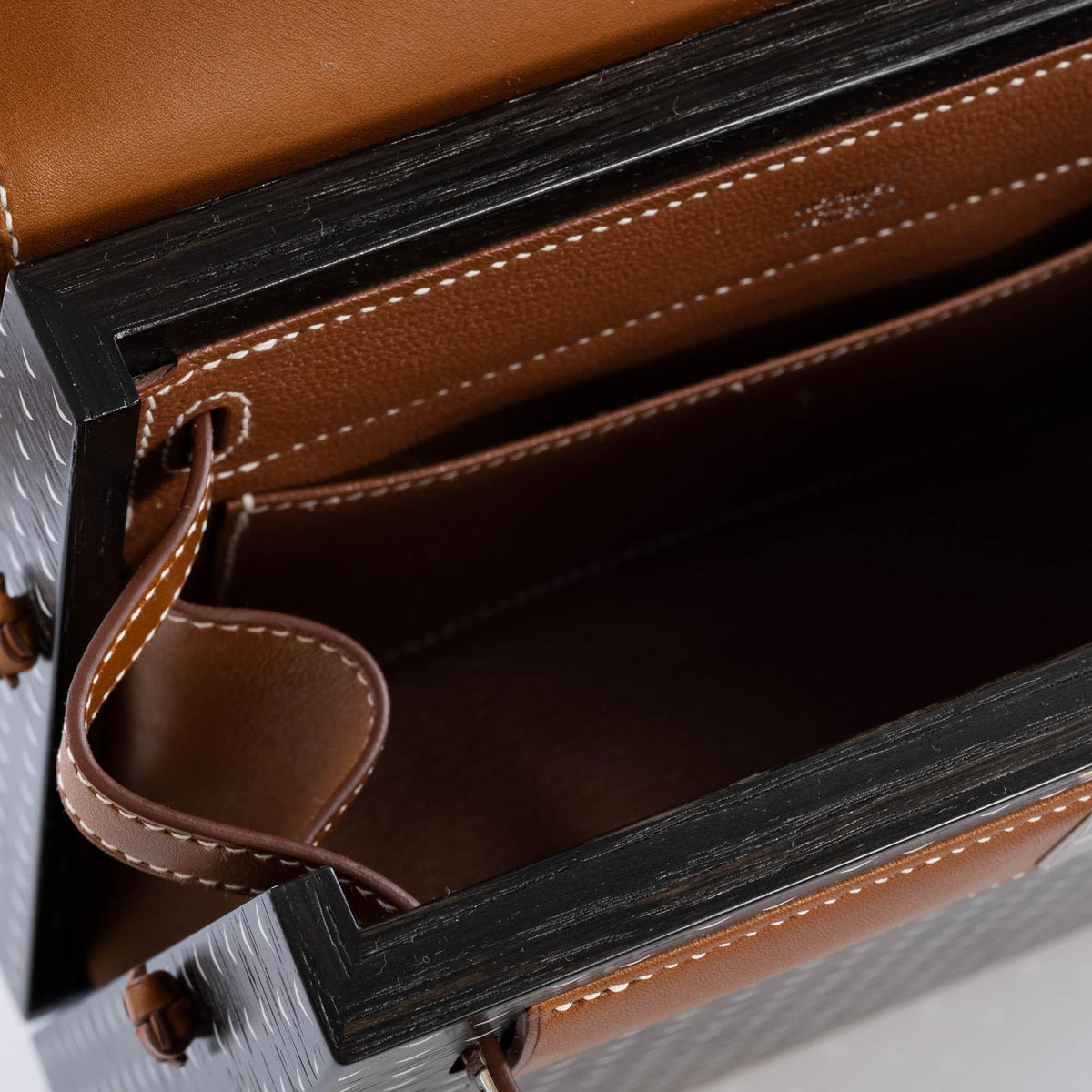 The bag being carried by hand, showcasing its elegant size
