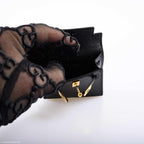 Close-up of the gold-tone hardware and toggle closure on the Kelly Charm