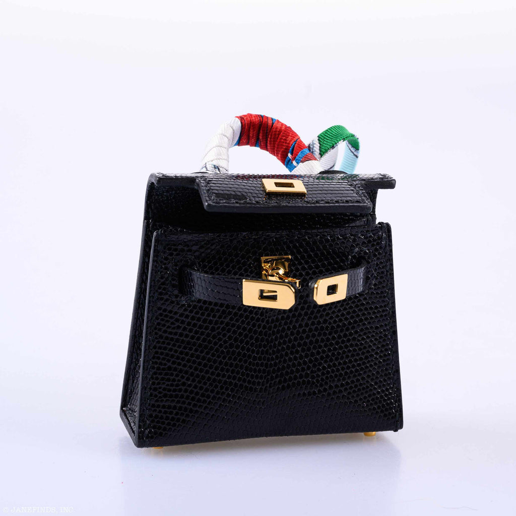 The micro charm displayed with its accompanying box and accessories