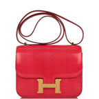 Hermes Mini Constance 18 handbag in Rouge Exotique Niloticus lizard with gold hardware.