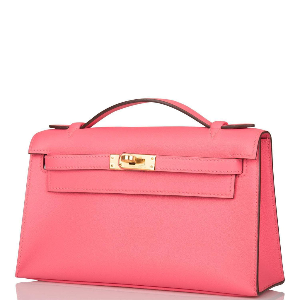 Hermes Rose Azalee Swift Mini Kelly Pochette Gold Hardware, The Mini Kelly Pochette being carried by hand, sho