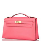 Hermes Rose Azalee Swift Mini Kelly Pochette Gold Hardware, The Mini Kelly Pochette being carried by hand, sho
