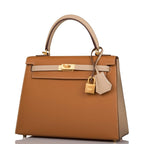 A view of the signature brushed gold-tone turn-lock on the front flap of the bag