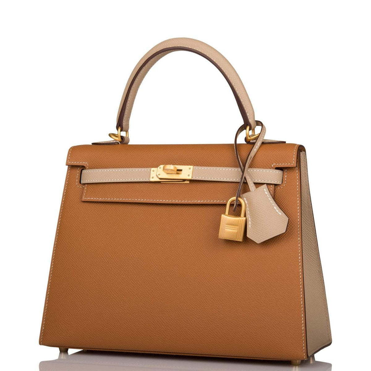 A view of the signature brushed gold-tone turn-lock on the front flap of the bag