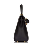 Close-up of gold hardware, handle, and toggle lock of Hermes Kelly 25