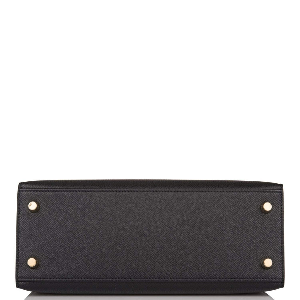 Styled shot of Hermes Kelly 25 being carried with shoulder strap