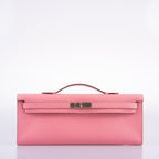 Side profile of Kelly Cut clutch in pink Epsom leather