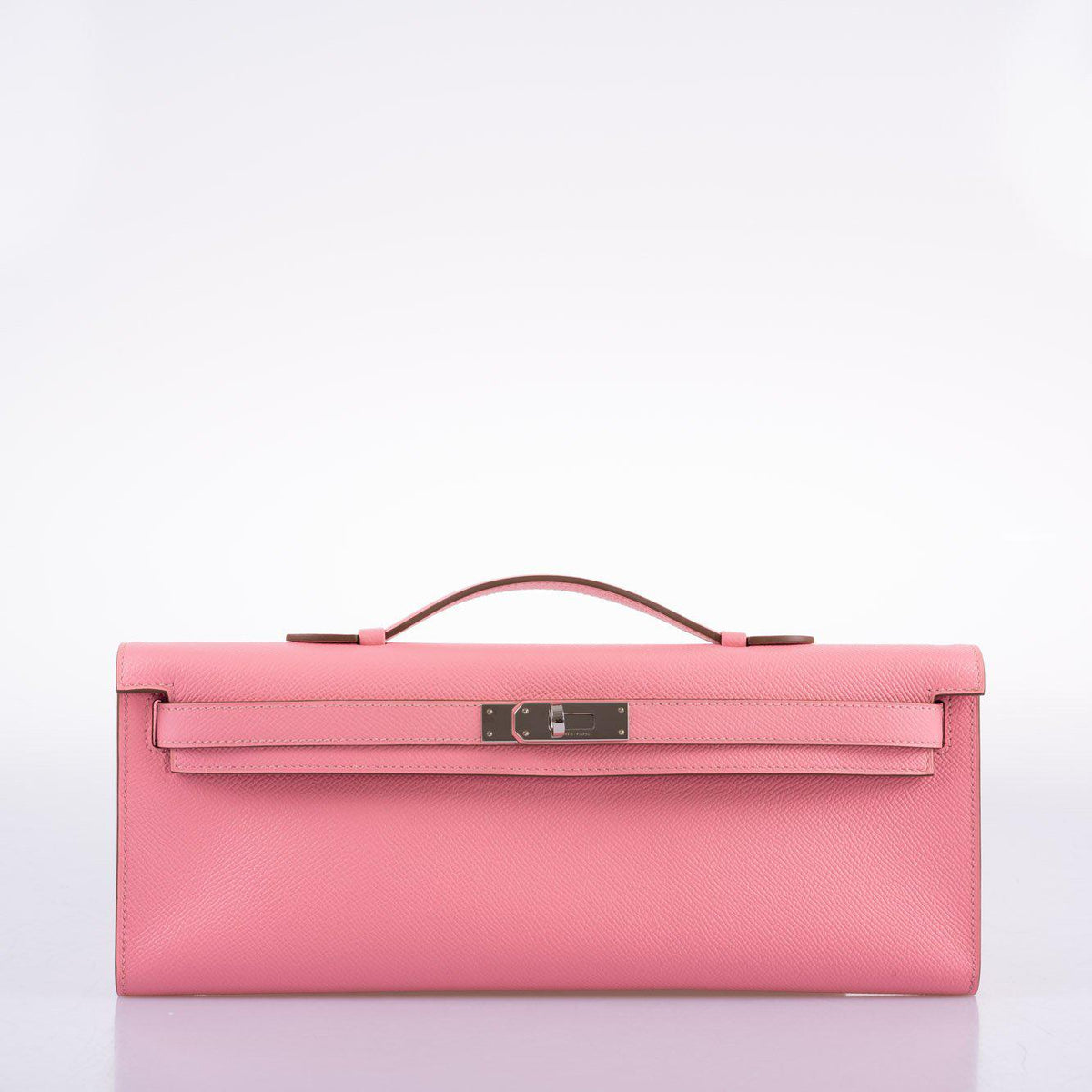 Side profile of Kelly Cut clutch in pink Epsom leather