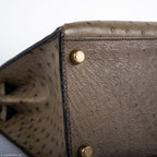 Hermes Kelly 28 Sellier Mousse Ostrich Gold Hardware - Circle W, Hand-held view of Kelly 28 for scale referenc