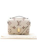The bag carried on the forearm, highlighting its top handle carry option